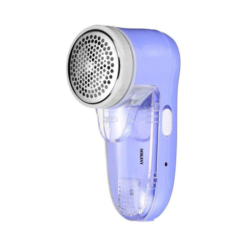 Electric lint remover used on sofa removing lint bobbles fuzz