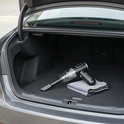 Portable car vacuum cleaner stored in car boot with cloth