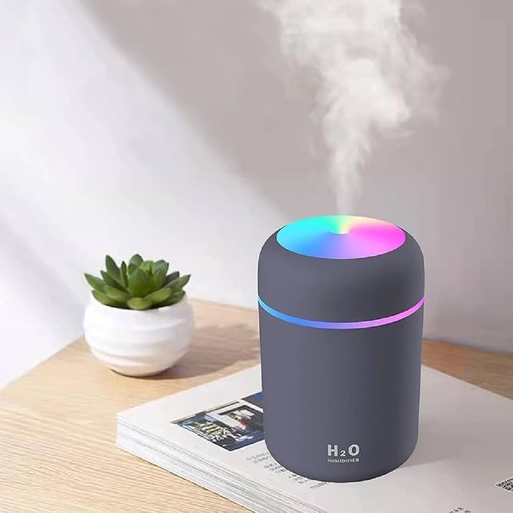Mini H2O humidifier cool mist RGB glow on desk with plant
