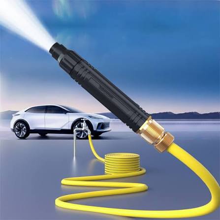 High pressure car wash spray gun with yellow hose connected to car