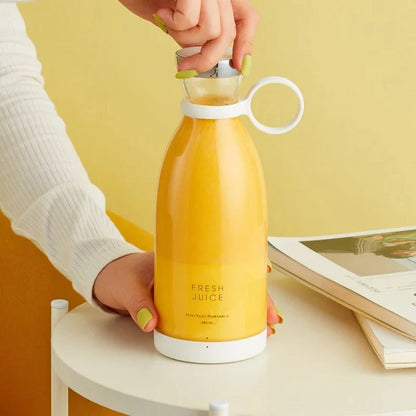 Woman adding strawberries to portable juicer bottle