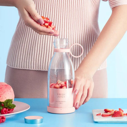 Portable juicer bottle with mixed fruits and smoothie glass